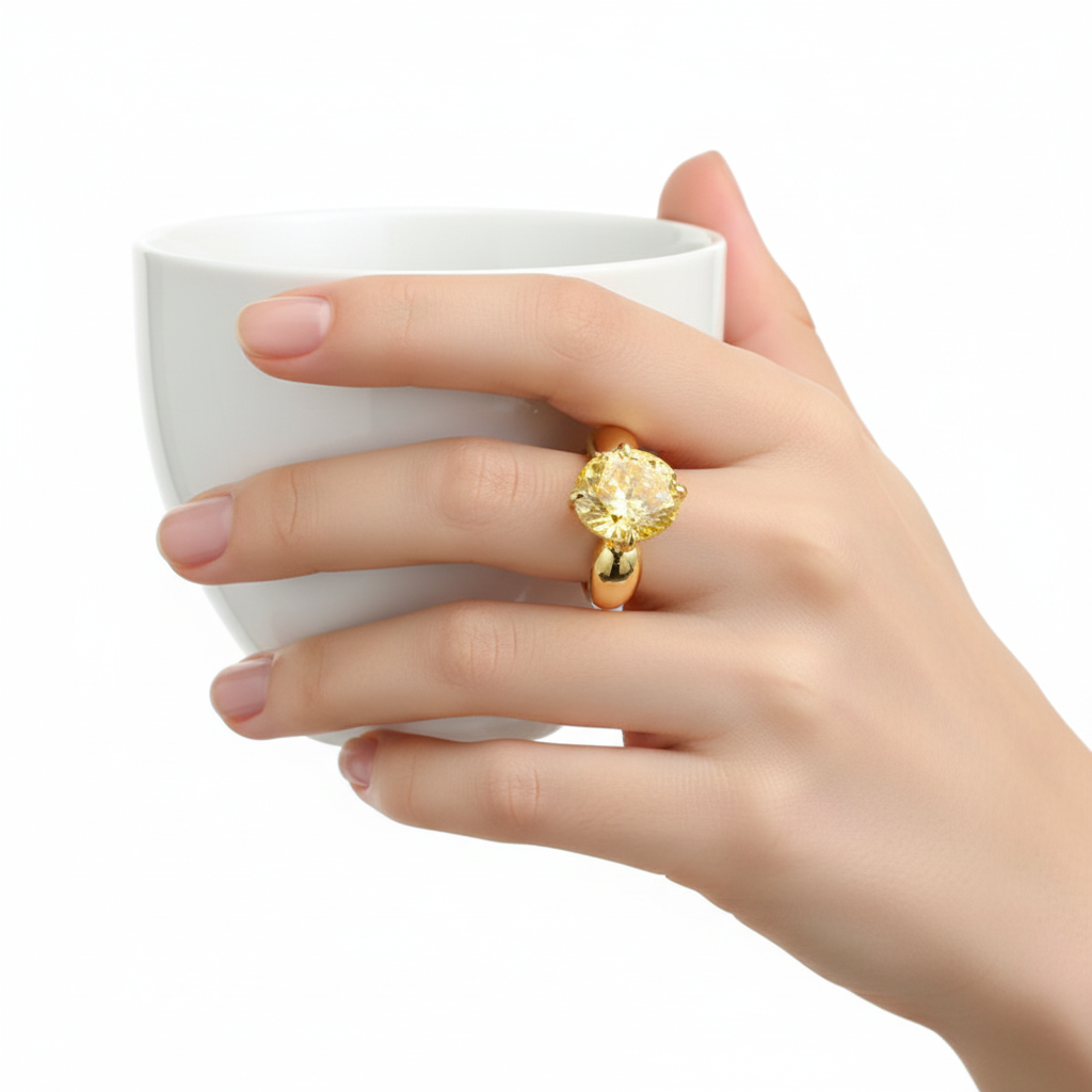 Yellow Diamond Ring on Hand with Coffee